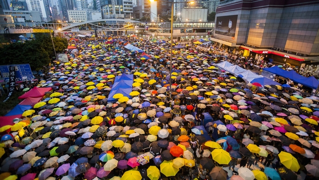 Pro-democracy protesters open their umbrellas for 87 seconds, marking the 87 rounds of tear gas that were fired by the Hong Kong police