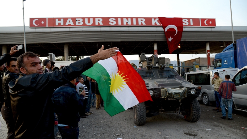 Turkish Kurds celebrate as Peshmerga fighters cross through the Turkish-Iraqi border