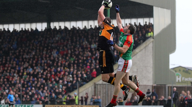 Austin Stacks' Kieran Donaghy and Fergal Griffin of Mid Kerry jump for the ball during the Kerry SFC final