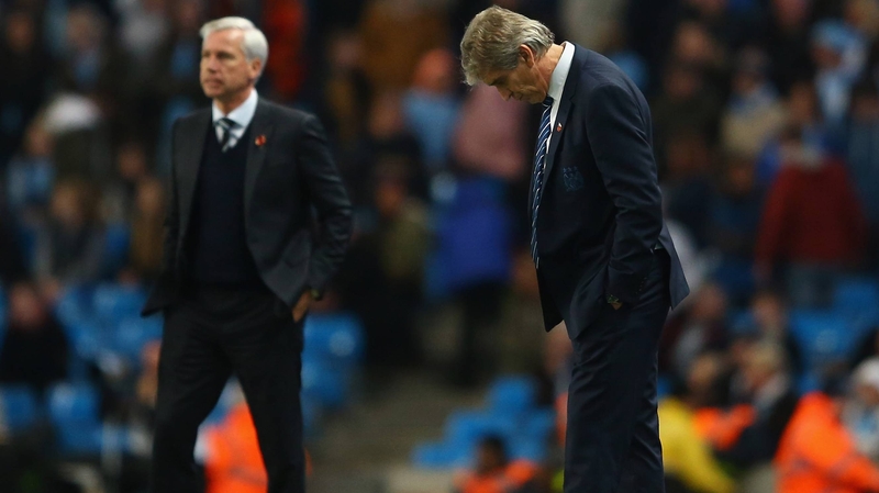 Newcastle's Alan Pardew (L) and Manuel Pellegrini of Manchester City watch their sides last night