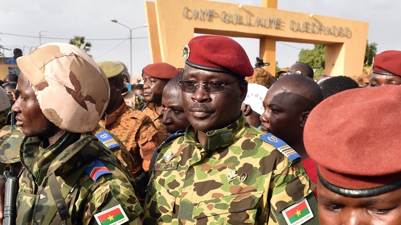 Lieutenant Colonel Issaac Zida (centre) has promised to lead Burkina Faso to elections