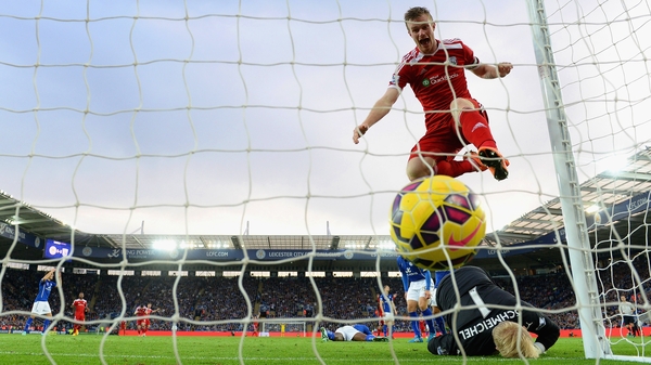 West Brom's Chris Brunt celebrates as he jumps over Kasper Schmeichel of Leicester City after Esteban Cambiasso scored an own goal