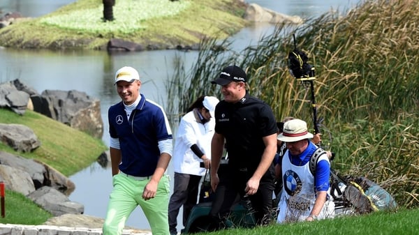 Marcel Siem (l) of Germany walks alongside Jamie Donaldson of Wales