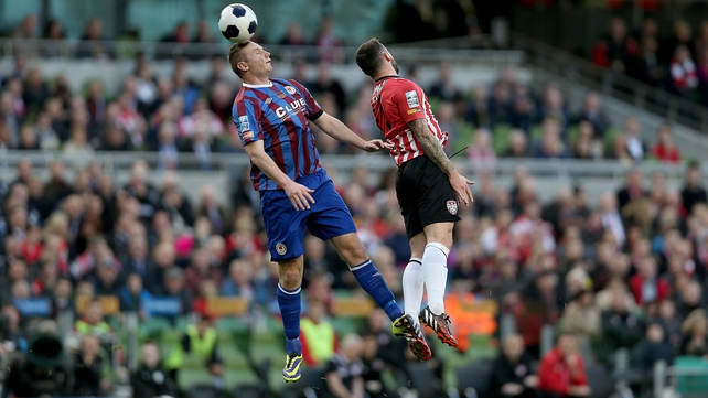 Kenny Browne beats Rory Patterson to the ball in an early aerial challenge