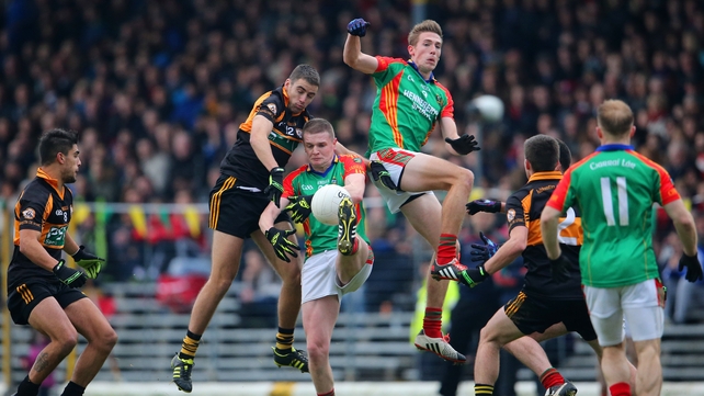 Austin Stacks' Fiachna Mangan with Martin Burke and Tomas Ladden of Mid Kerry during the game...
