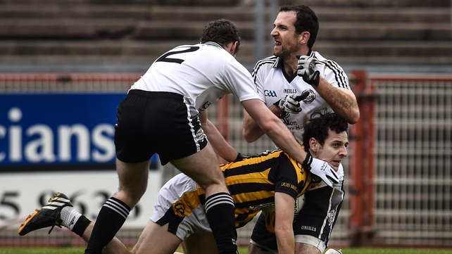Hugh Gallagher with Justin McMahon and Jamie Clarke battling for the ball during the game