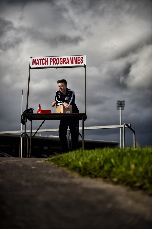 Omagh's Cain Bradley helps out selling programmes ahead of the Ulster SFC quarter-final game
