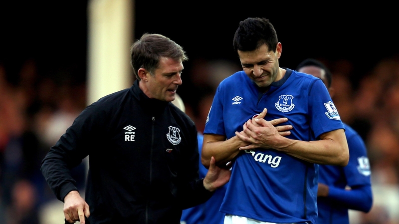 Antolin Alcaraz of Everton leaving the field against Swansea with a shoulder injury