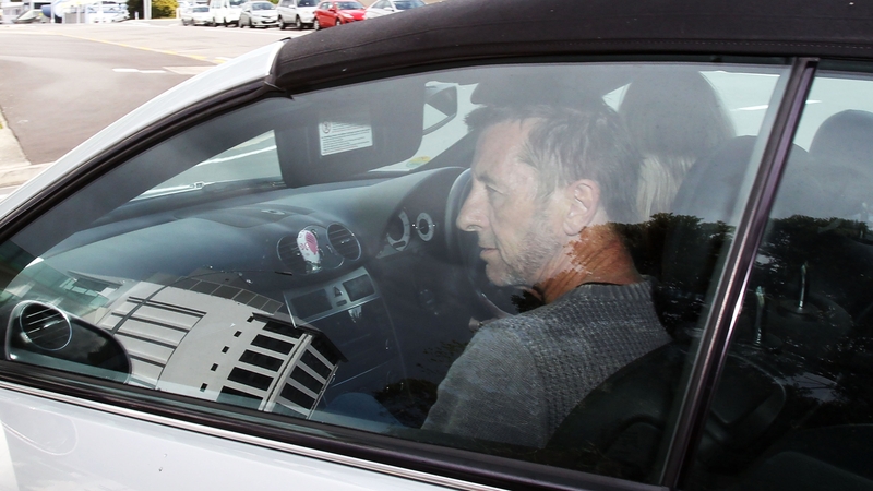Phil Rudd leaves Tauranga District Court after being charged with attempting to procure murder