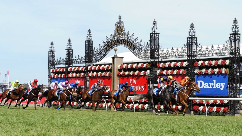 Hugh Bowman celebrates after steering Terravista to victory in the Darley Classic as Slade Power and Wayne Lordan (red and white check cap) trail home in 11th place