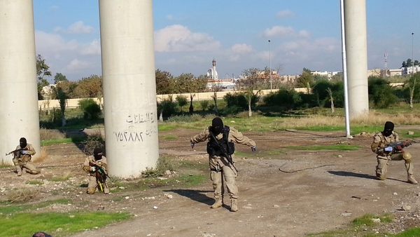 Fighters of the Islamic State terrorist group take part in a military training in Mosul city