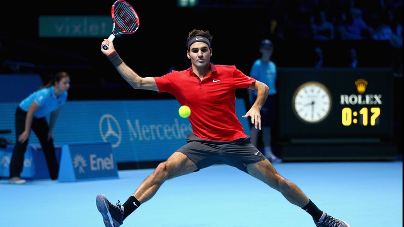 Roger Federer stretches to play a defensive forehand at the O2