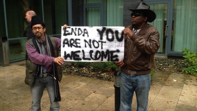 Several protesters remain outside the hotel