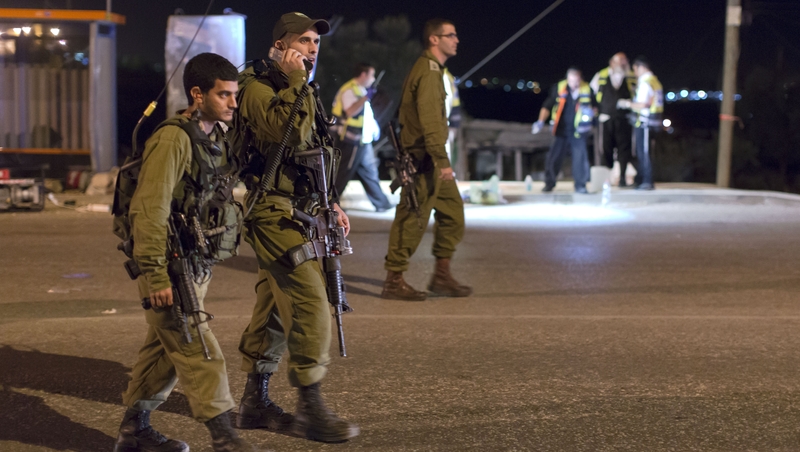 Israeli soldiers patrol close to the scene, in the West Bank, where a woman was allegedly stabbed to death