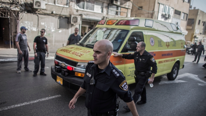 Israeli policemen escort an ambulance transporting the Palestinian who allegedly stabbed an Israeli soldier after his arrest in Tel Aviv yesterday