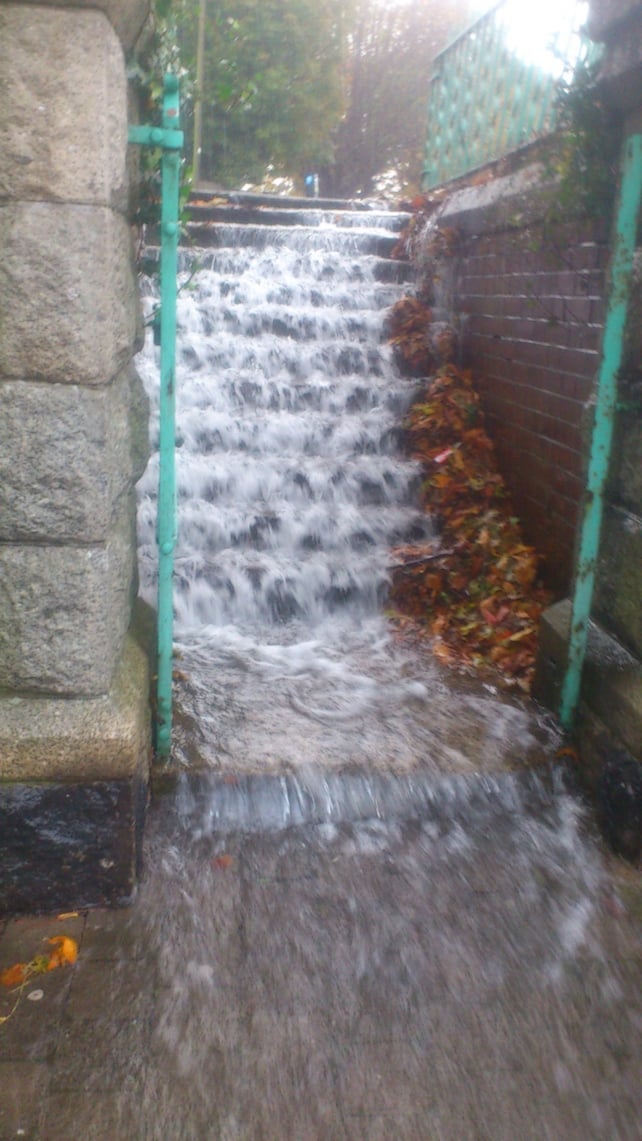 Water rushes down steps to a carpark on Herbert Road in Bray (Pic: Jay Mahon)