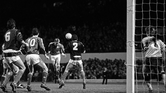 John Byrne heads the ball goalwards