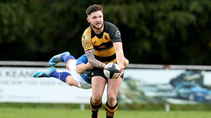 Young Munster's Dan Goggin with Marcus O'Driscoll of St Mary's College