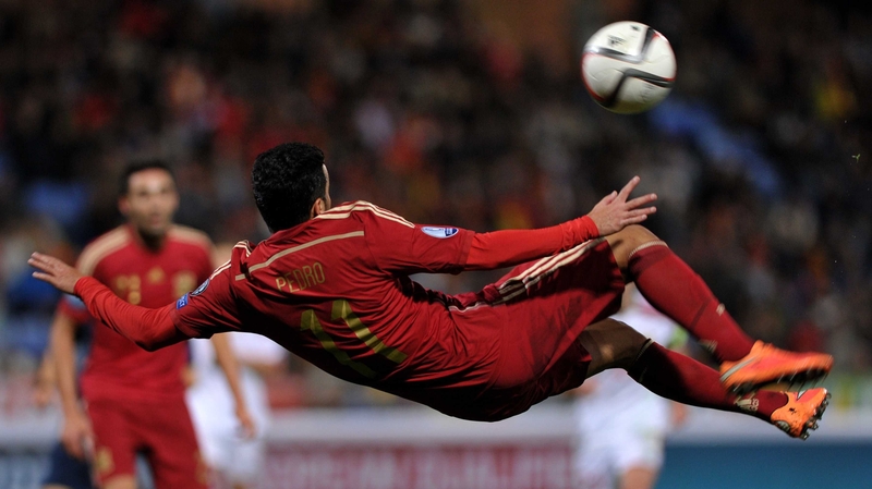 Spain Pedro makes an acrobatic attempt to connect with the ball