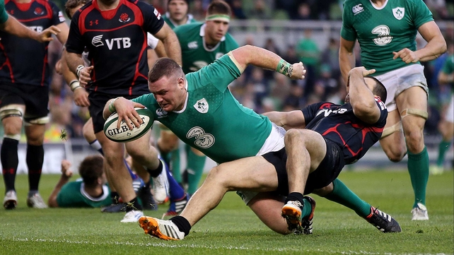 Ireland's Dave Kilcoyne can't be stopped scoring the first try despite David Kacharava's best efforts