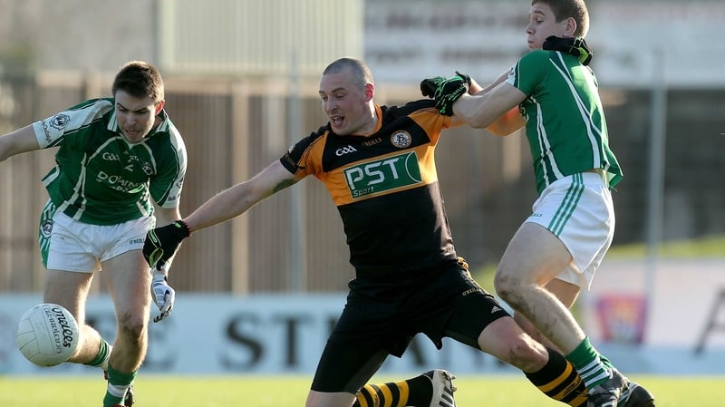 Austin Stacks' Kieran Donaghy (C) battles Stephen O'Donoghue (R) of Ballincollig