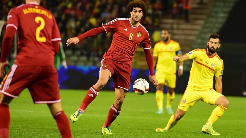 Belgium's Marouane Fellaini controls the ball as Joe Ledley looks on for Wales
