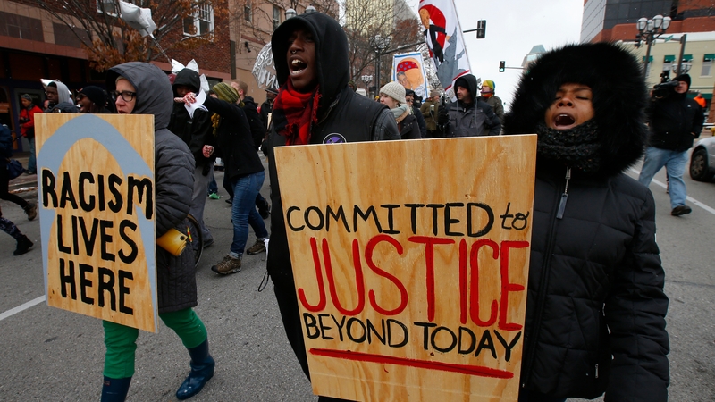 Protesters march down the streets in Clayton in Missouri
