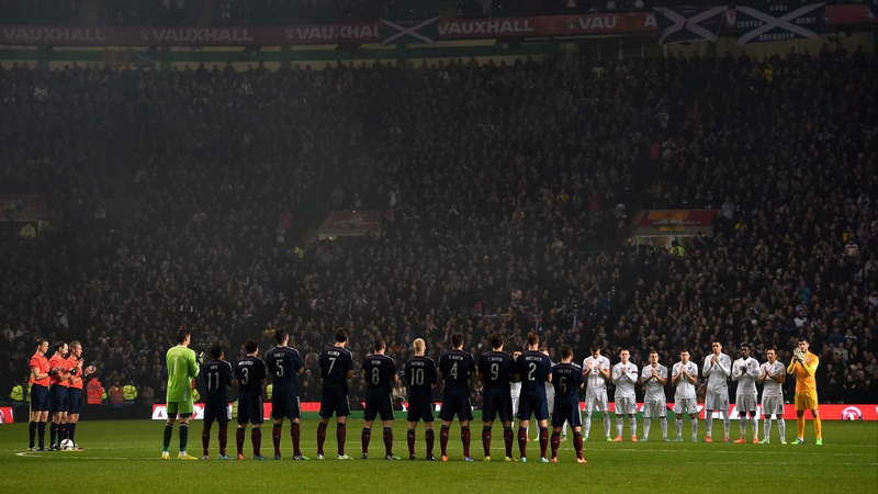 The teams stand for a minute's applause for Scotland supporter Nathan McSeveney, who died at the recent match against the Republic of Ireland