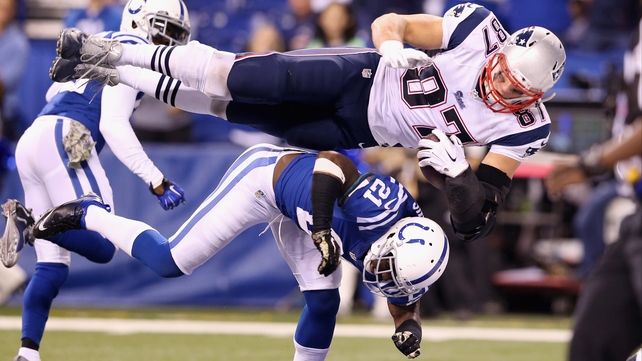 Rob Gronkowski 87 of the New England Patriots scores a touchdown against Vontae Davis 21 of the Indianapolis Colts on Sunday