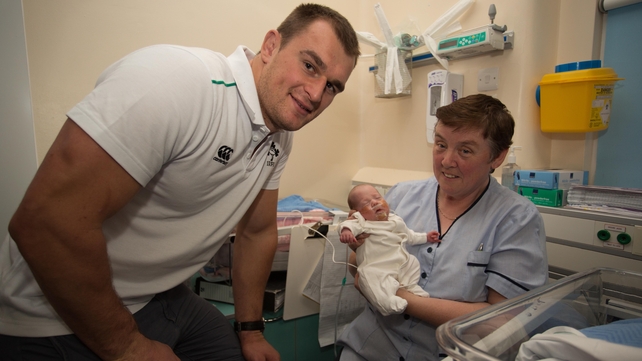 Rhys Ruddock with baby Mia, born at 23 weeks, and nurse Margaret Cooke during a visit by the Irish team to the National Maternity Hospital, Holles Street on Thursday
