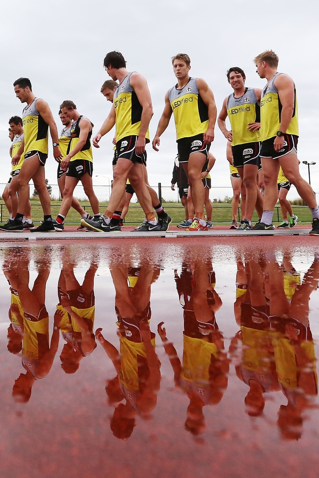 Players warm down after a 2km time trial during a St Kilda Saints AFL pre-season training session at Casey Fields, Melbourne