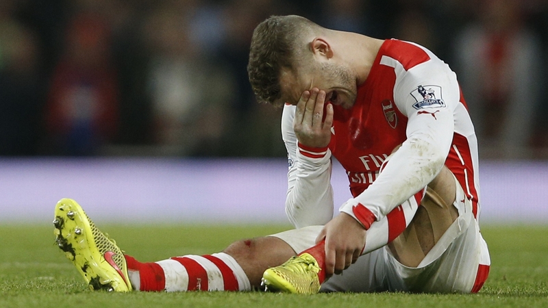 Jack Wilshere lies injured during the match between Arsenal and Manchester United