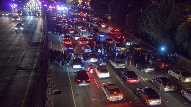 Protesters and California Highway Patrol officers face off on Highway 580 in Oakland, California