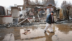 Ferguson property manager Terri Willits looks over a gas station she manages that was set on fire when rioting erupted
