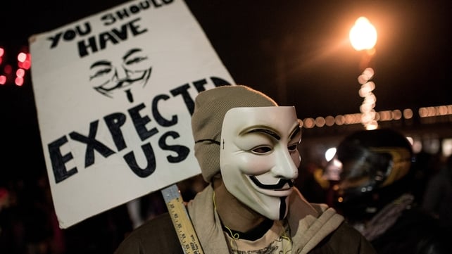 A protester wearing an Anonymous mask is seen during a protest in Ferguson