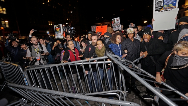 Demonstrators push over a police barricade in Union Square, New York