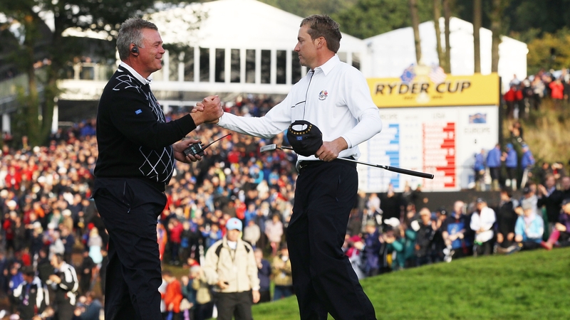 Then Europe Vice Captain Darren Clarke (L) shakes hands with Ian Poulter during the 2010 Ryder Cup