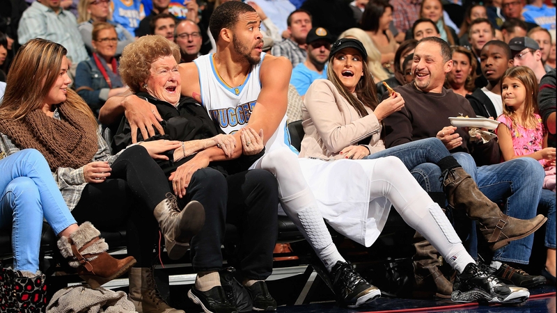 JaVale McGee of the Denver Nuggets gets up close and personal with a surprised fan at Pepsi Center in Colorado