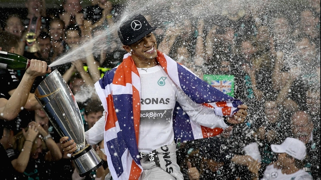 Britain's Lewis Hamilton celebrates winning a second Formula One world title