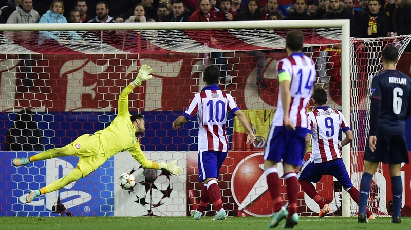 Atletico Madrid's Croatian forward Mario Mandzukic (no. 9) scores past Olympiakos' Spanish goalkeeper Roberto
