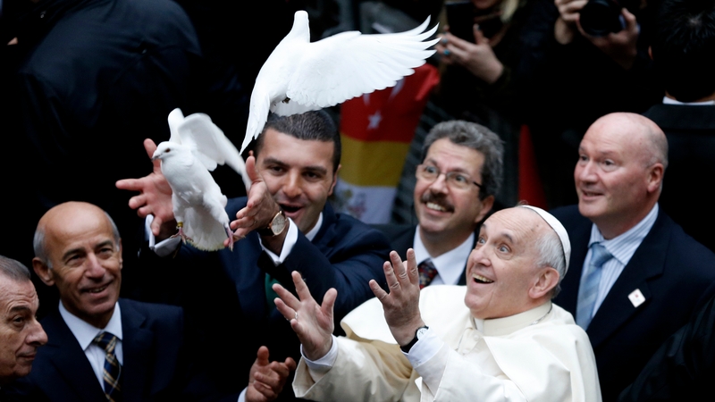 Pope Francis releases white doves as he arrives at St Esprit church for a service in Istanbul