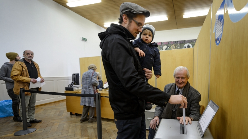 A voter casts his ballot in the old town of Fribourg