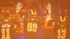 St Louis Rams players hold their arms up in tribute to Michael Brown, who was shot dead in Ferguson, during their victory over the Oakland Raiders