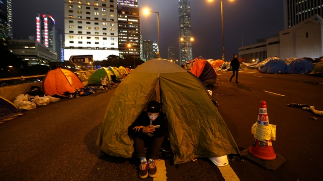 A pro-democracy student sits outside his tent at the mass civil disobedience campaign Occupy Hong Kong camp