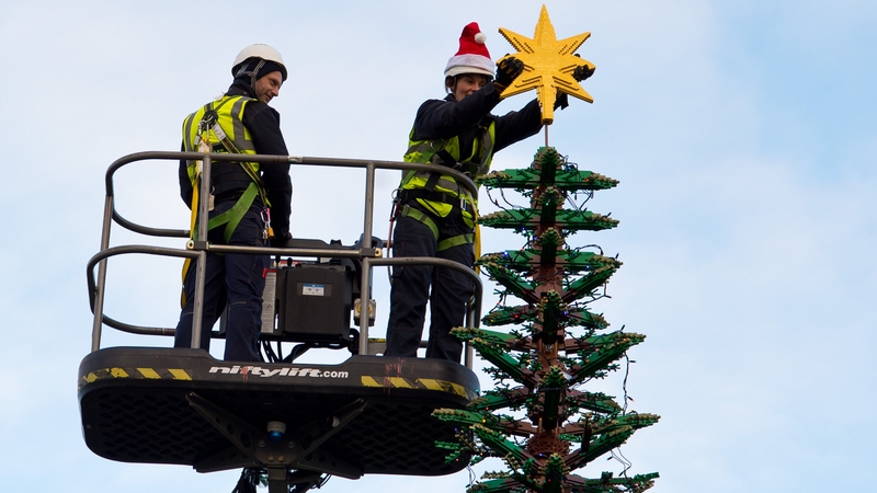 Workers at Legoland Windsor top a 9m Christmas tree made of Lego with a Lego star
