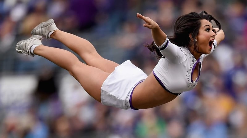 A Baltimore Ravens cheerleader takes flight at M&T Bank Stadium in Baltimore, Maryland