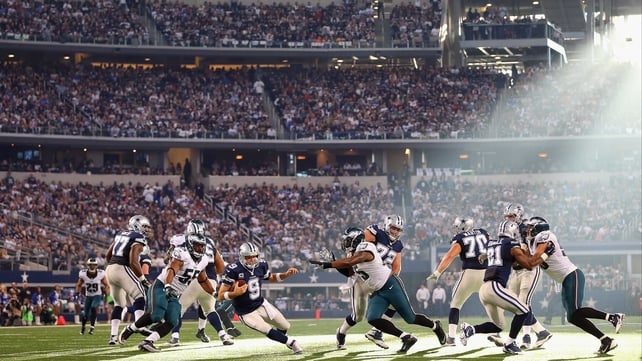 Tony Romo of the Dallas Cowboys under pressure from the Philadelphia Eagles at Cowboys Stadium in Arlington, Texas