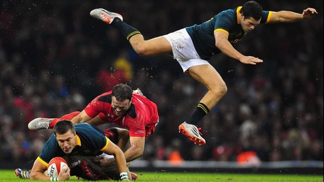 Wales' Jamie Roberts tackles Handre Pollard as Jan Serfontein of South Africa goes flying during the Autumn international at Millennium Stadium