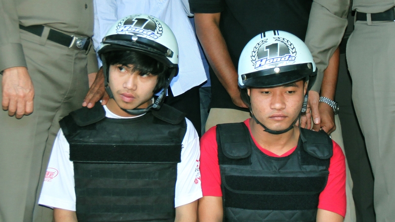 The suspects attend a press conference with police on the beach of Koh Tao