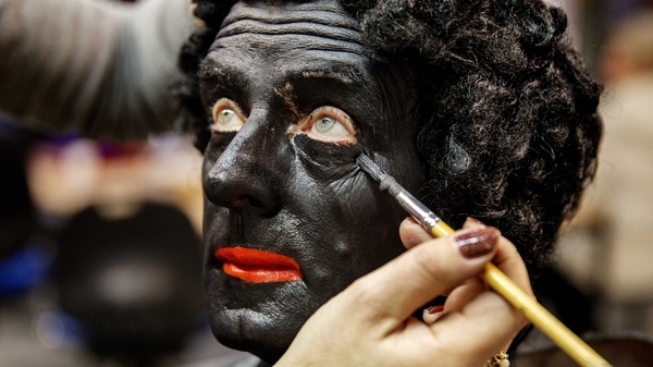A make-up artist works on a man dressed as Zwarte Piet in the Sinterklaascentrale in Soest, The Netherlands